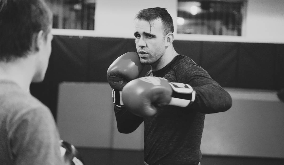 The Kru training his student in a muay thai gym