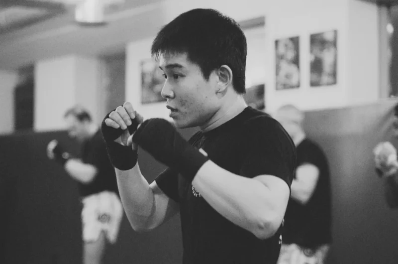 A Montrait Muay Thai student is practicing punches during class.