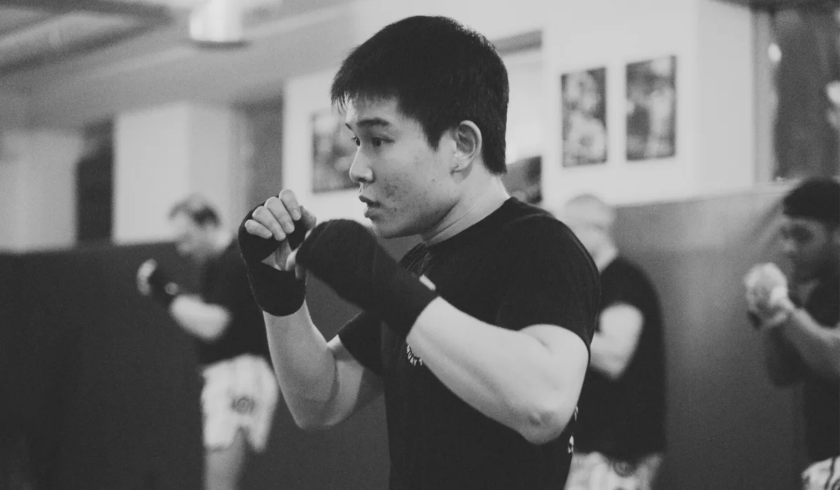 A Montrait Muay Thai student is practicing punches during class.