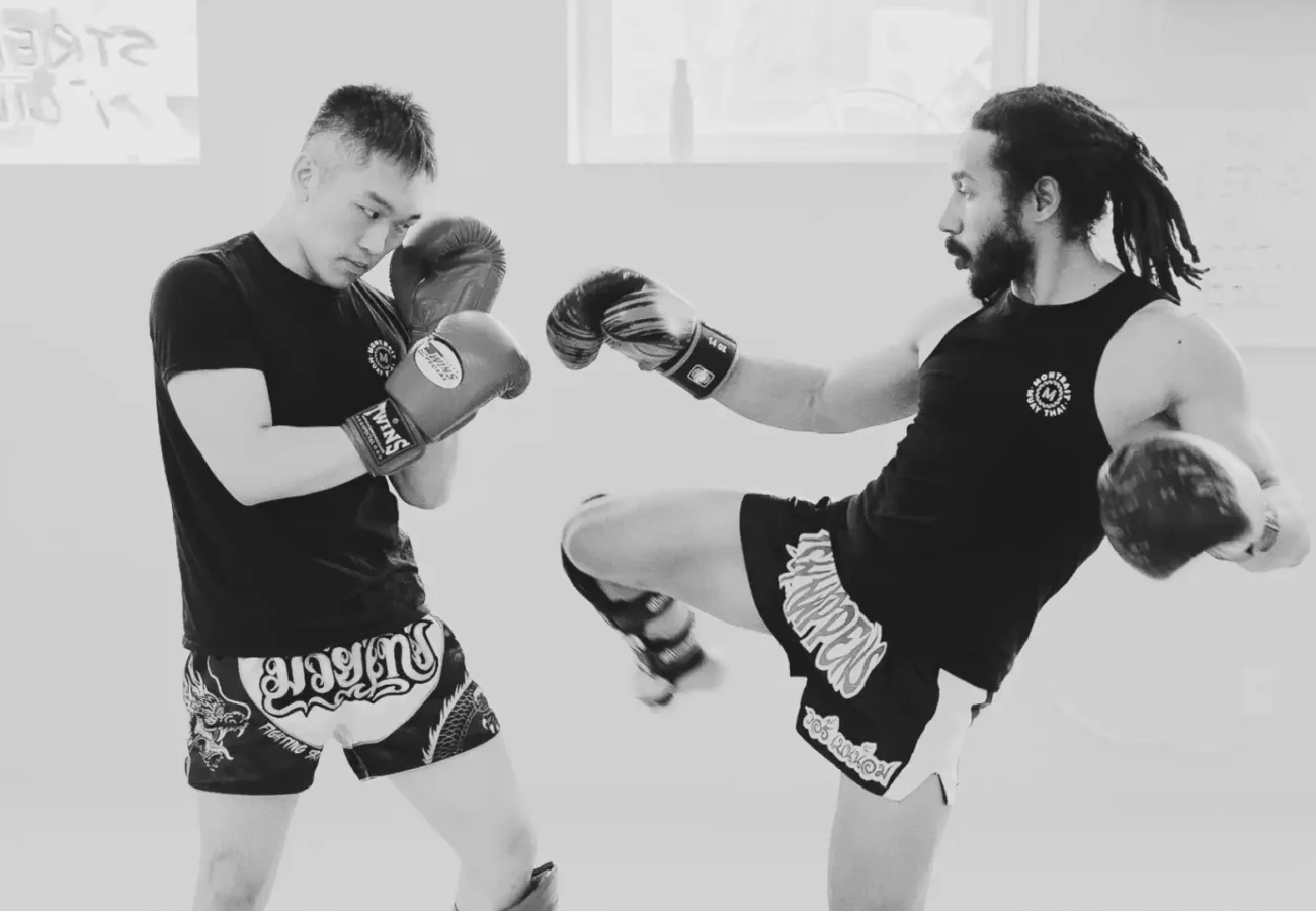 two muay thai students in the gym
